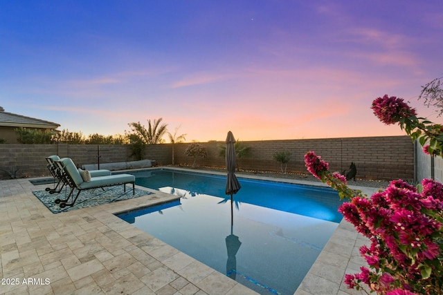 view of pool at dusk