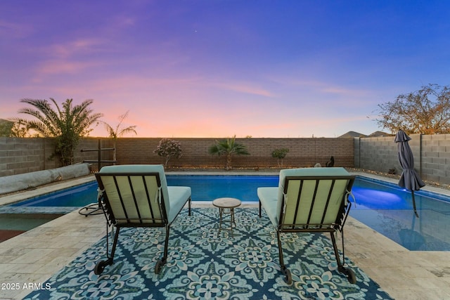 view of pool at dusk