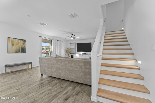 living room featuring ceiling fan and wood-type flooring