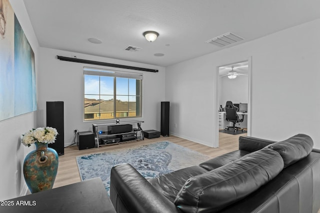 living room featuring light wood-type flooring and ceiling fan