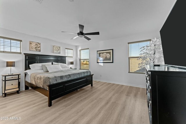 bedroom featuring multiple windows, ceiling fan, and light hardwood / wood-style floors