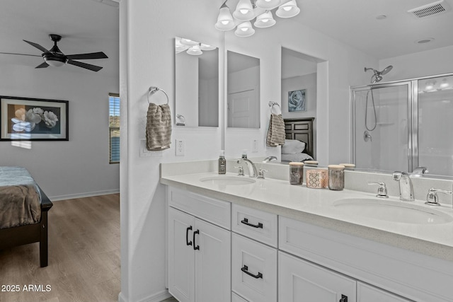 bathroom featuring an enclosed shower, wood-type flooring, vanity, and ceiling fan