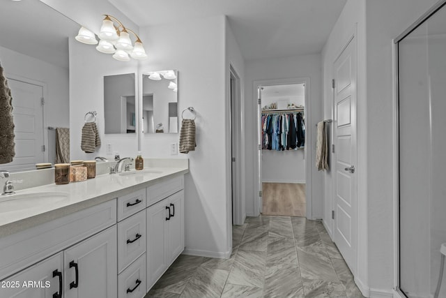 bathroom featuring vanity and a shower with door