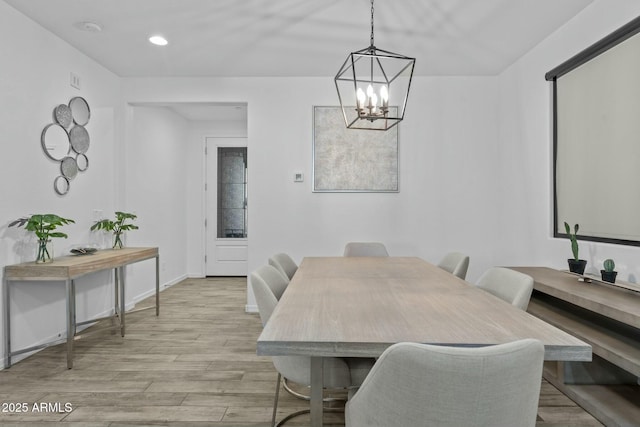 dining area with a chandelier and light hardwood / wood-style floors