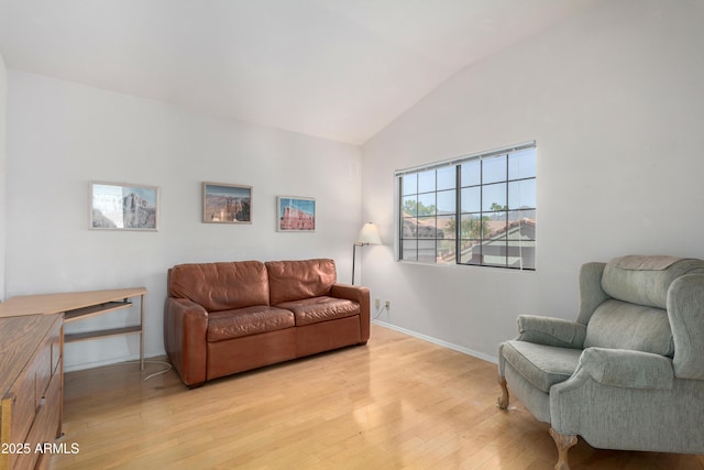 living room featuring light hardwood / wood-style floors and lofted ceiling