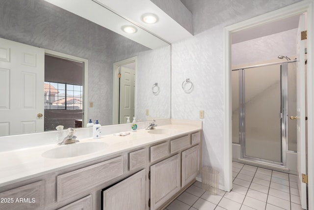 bathroom with an enclosed shower, vanity, and tile patterned flooring