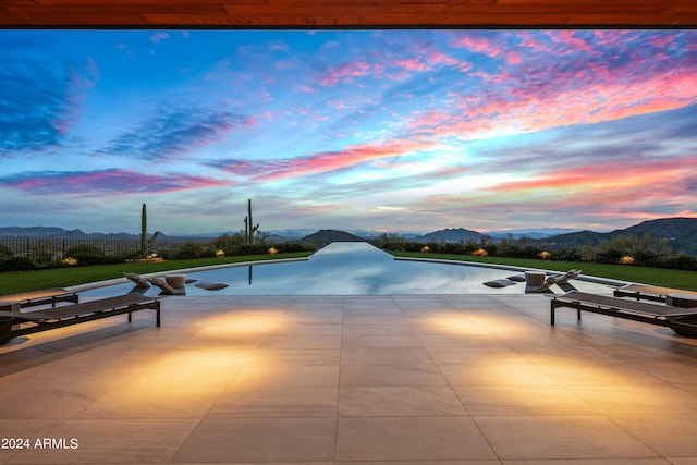 pool at dusk with a mountain view