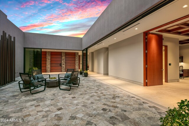 view of patio terrace at dusk