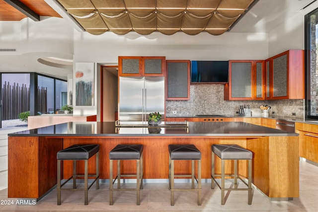 kitchen featuring a center island, appliances with stainless steel finishes, and decorative backsplash