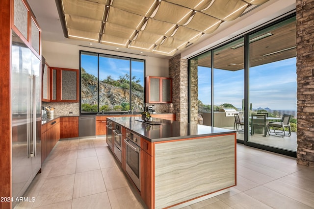 kitchen featuring a kitchen island, stainless steel appliances, and decorative backsplash