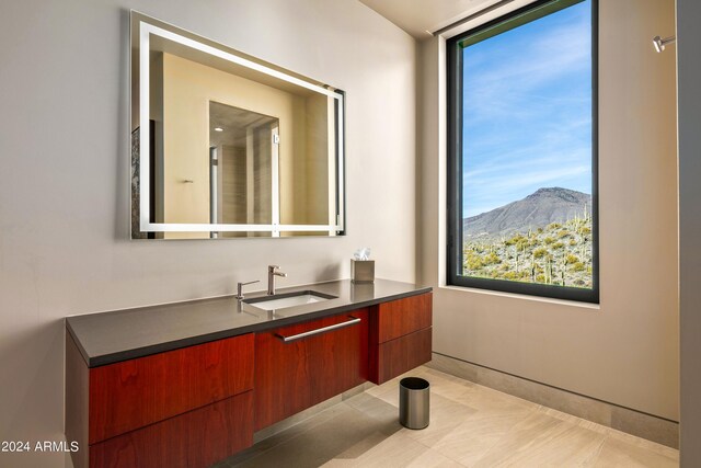 bathroom with a mountain view, vanity, and tile patterned floors