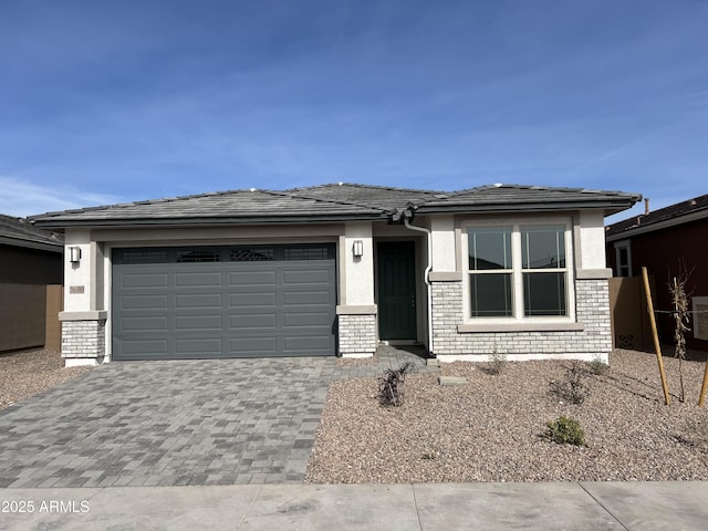 39980 W Elm Dr, Maricopa, AZ 85138 - prairie-style home featuring an attached garage, driveway, and brick siding