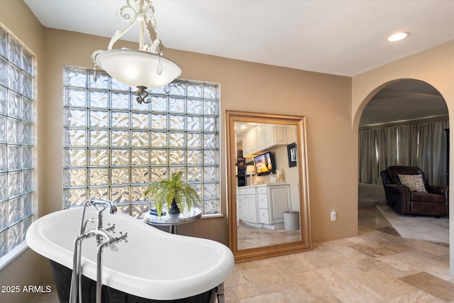 bathroom with a tub to relax in