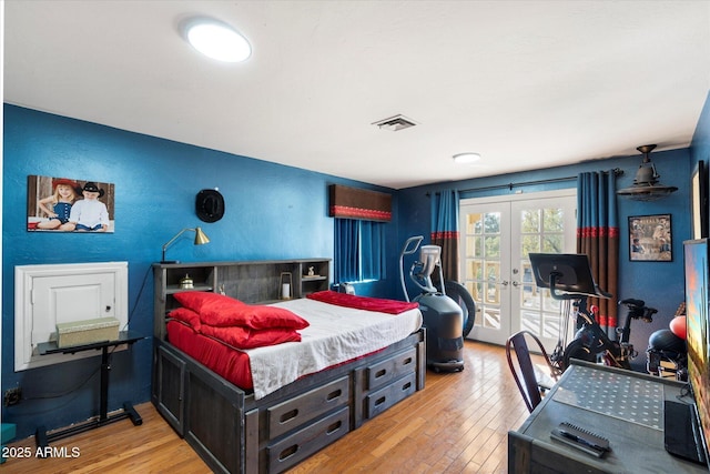 bedroom featuring french doors, access to exterior, and light wood-type flooring