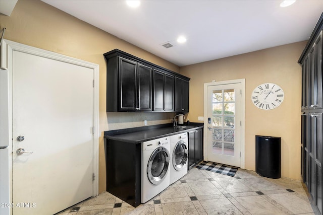 washroom featuring light tile patterned flooring, cabinets, washer and clothes dryer, and sink