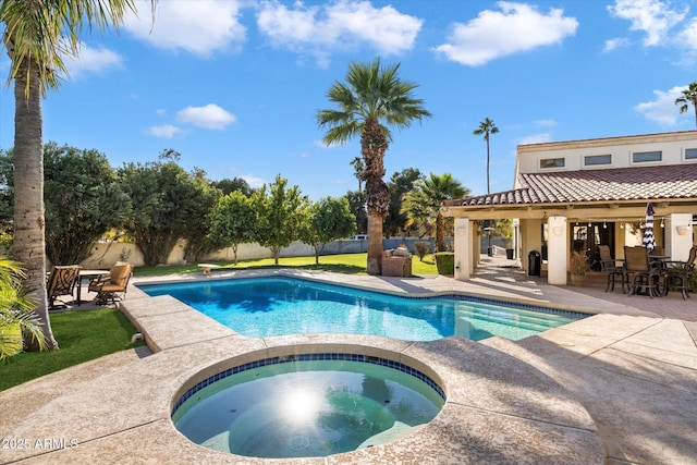 view of swimming pool with an in ground hot tub and a patio area