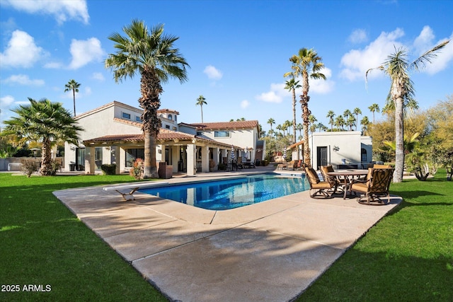 view of pool with a yard and a patio area