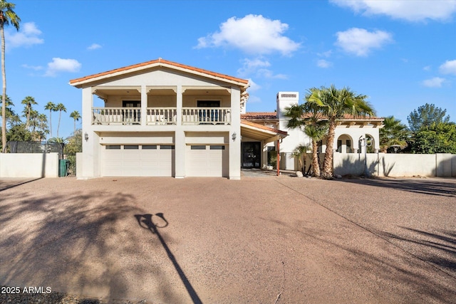 view of front facade featuring a garage and a balcony