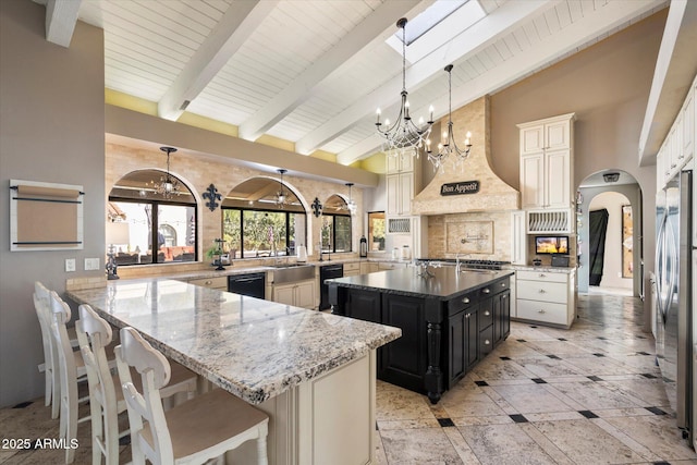 kitchen featuring hanging light fixtures, stainless steel appliances, a center island, light stone countertops, and kitchen peninsula