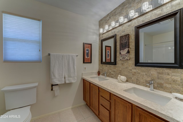 bathroom with tile patterned flooring, vanity, toilet, and decorative backsplash