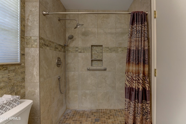 bathroom with curtained shower and toilet