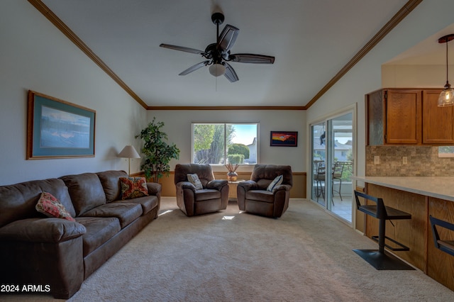 carpeted living room with ceiling fan, ornamental molding, and vaulted ceiling