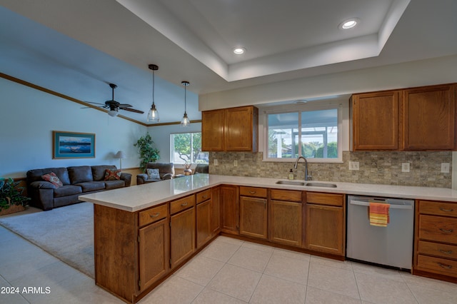 kitchen featuring kitchen peninsula, decorative backsplash, dishwasher, and sink