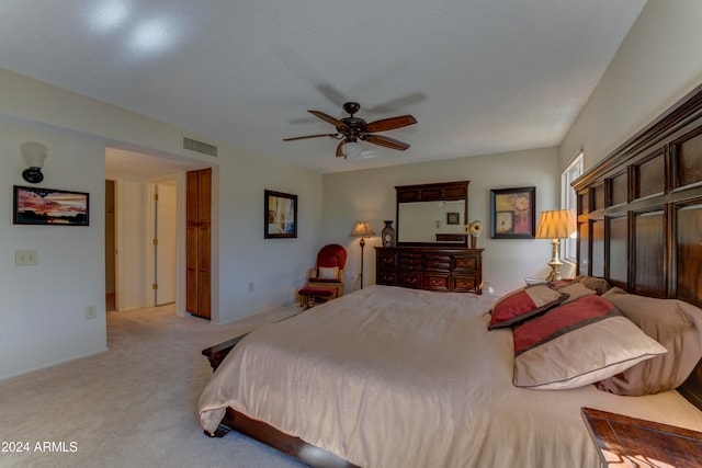 bedroom featuring light carpet and ceiling fan