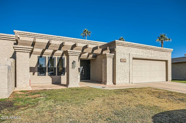 view of front of home with a garage and a front lawn