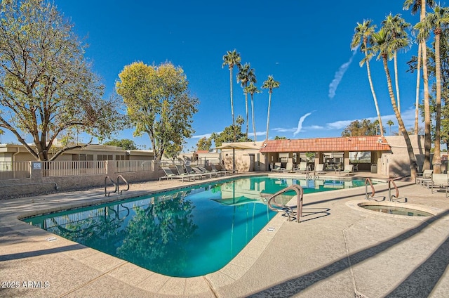 view of swimming pool featuring a community hot tub and a patio