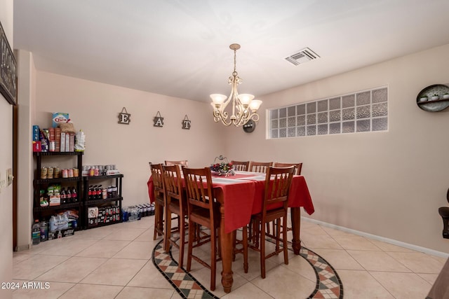 dining space featuring light tile patterned floors and a notable chandelier