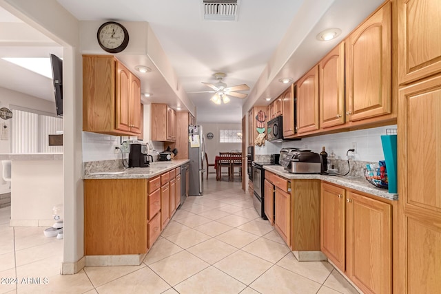 kitchen featuring backsplash, black appliances, ceiling fan, light stone countertops, and light tile patterned floors