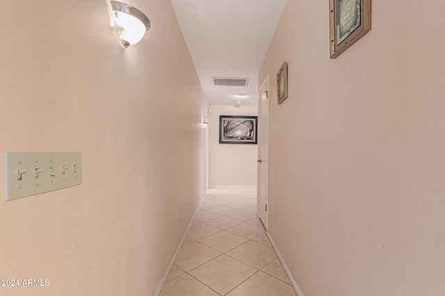 corridor featuring light tile patterned floors