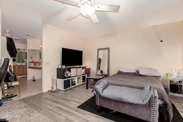 bedroom with ceiling fan and light hardwood / wood-style floors