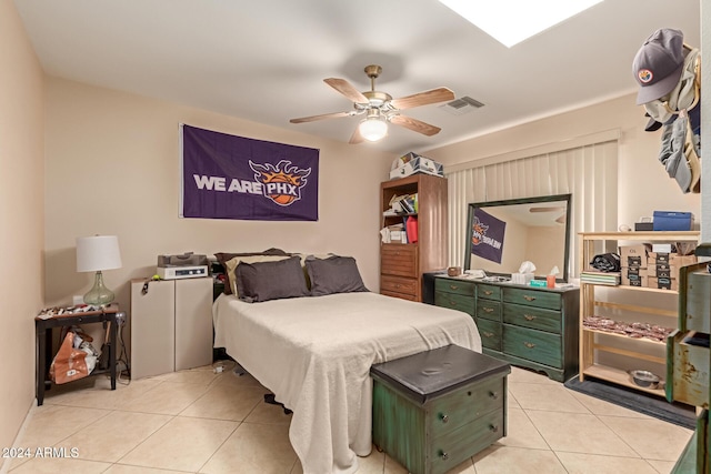 tiled bedroom featuring ceiling fan