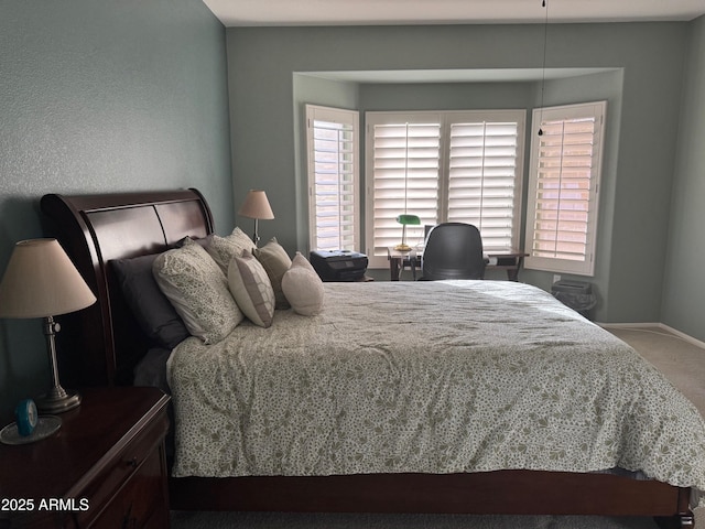 bedroom with carpet flooring and baseboards
