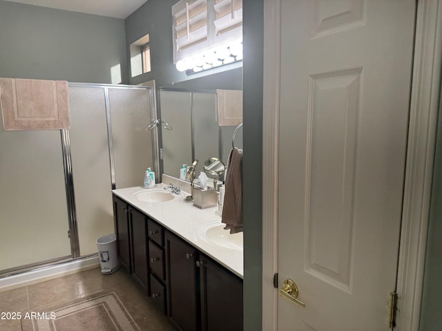 full bathroom with tile patterned flooring, a sink, and a stall shower