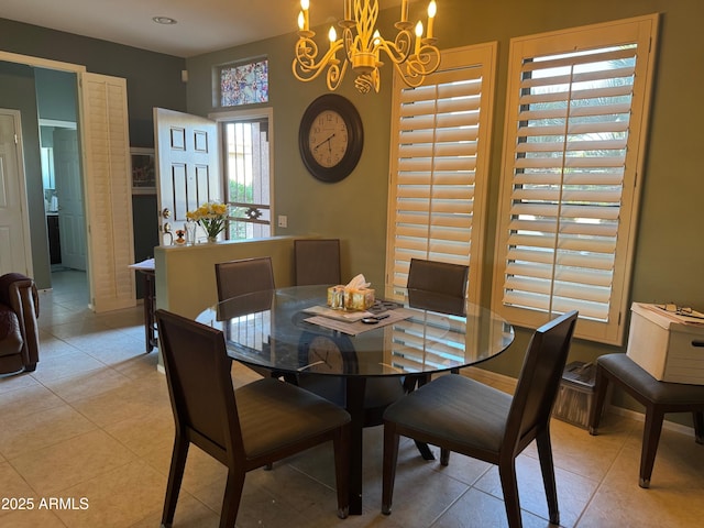 dining space with a notable chandelier and light tile patterned floors