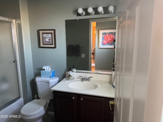 full bathroom featuring enclosed tub / shower combo, toilet, and vanity