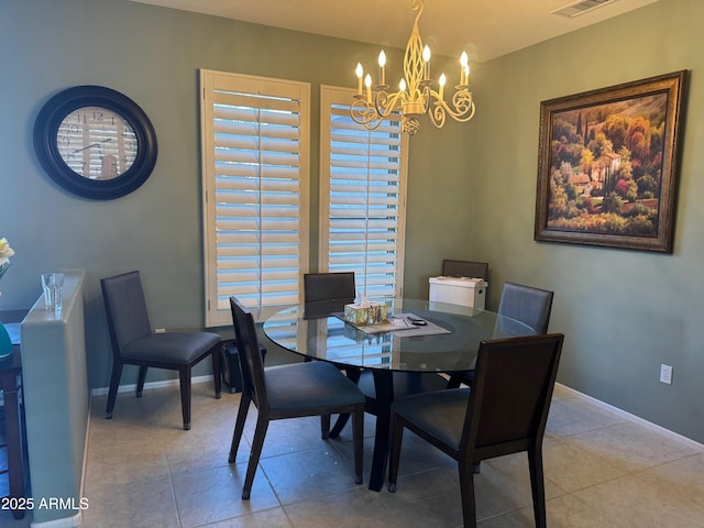 tiled dining space featuring a wealth of natural light, an inviting chandelier, visible vents, and baseboards