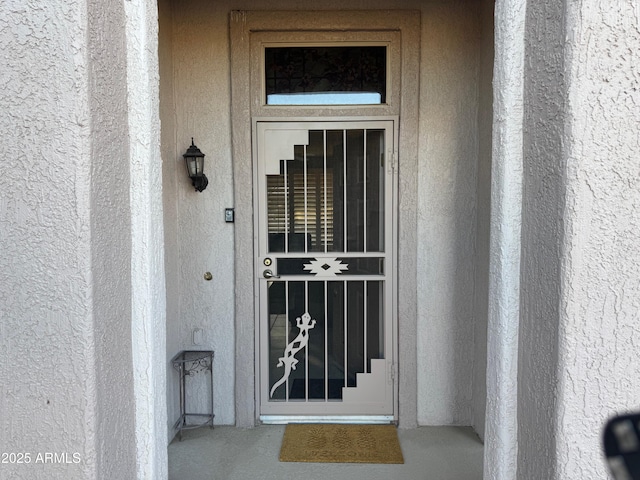 view of exterior entry with stucco siding