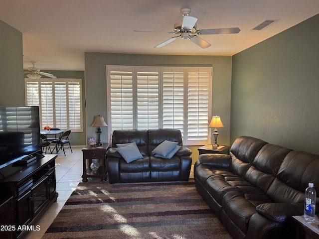 living room featuring visible vents, a ceiling fan, and tile patterned floors