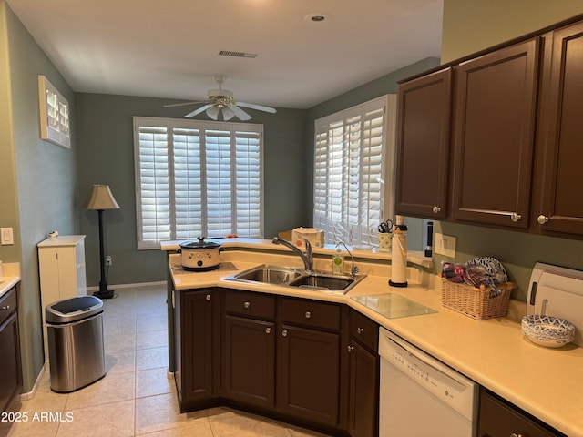 kitchen with a ceiling fan, white dishwasher, a sink, light countertops, and visible vents
