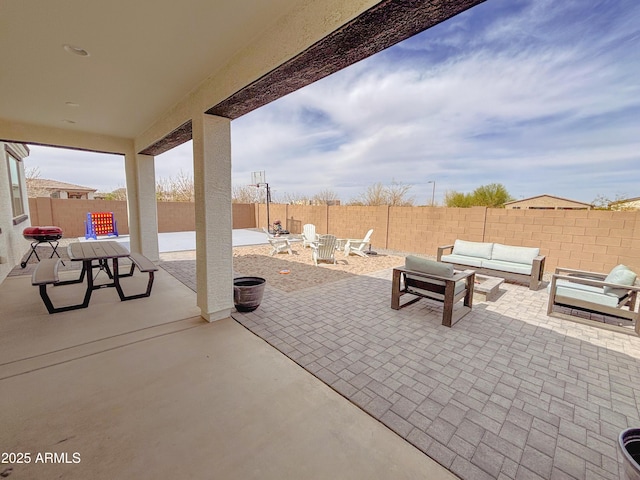 view of patio featuring a fenced backyard, an outdoor living space, and outdoor dining space