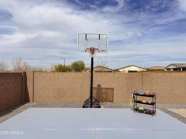 view of basketball court featuring fence