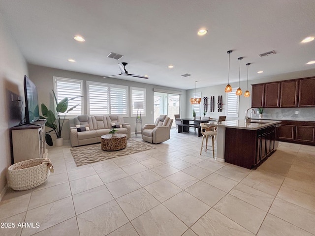 living room featuring light tile patterned floors, visible vents, and recessed lighting