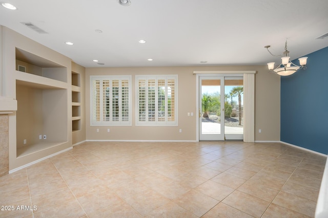 unfurnished living room with built in shelves, light tile patterned floors, and a notable chandelier