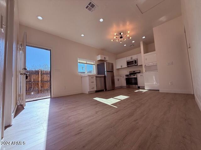 unfurnished living room featuring light hardwood / wood-style floors