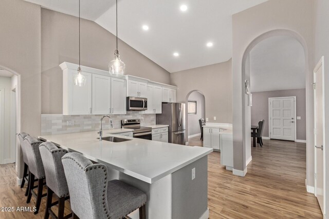 821 E Chicago St, Chandler, AZ 85225 - kitchen with appliances with stainless steel finishes, a breakfast bar, a sink, light countertops, and arched walkways