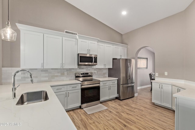 821 E Chicago St, Chandler, AZ 85225 - kitchen with a sink, arched walkways, stainless steel appliances, tasteful backsplash, and visible vents